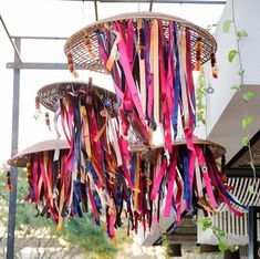 colorful ribbons hang from the ceiling in front of a building