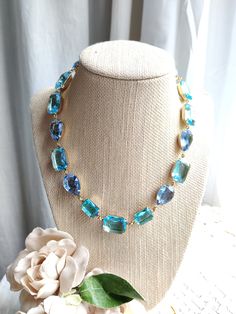 "Mixed shape collet necklace created with vintage swarovski crystals in aquamarine and pale sapphire blue. I wonderful mix of pear and octagon shapes and very soothing colors to wear to the office or an evening out...why not even with your favorite jean jacket? The settings are lacquered brass in gold, with custom artisan created findings. It's 16\" with a 2\" extender. This necklace is lovely for environmentally conscious women. All of the rhinestones are old stock swarovski and Czech glass, fr Light Blue Necklace, Peach Necklace, Clear Necklace, Green Statement Necklace, Blue Statement Necklace, Silk Necklace, Edwardian Jewelry, Crystal Choker Necklace, Peridot Necklace