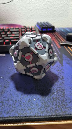 an origami ball sitting on top of a desk next to a computer keyboard