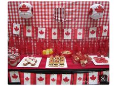 a red and white table topped with cakes and desserts