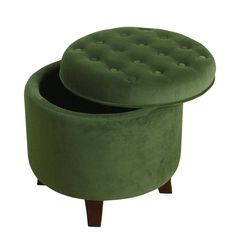 a green ottoman sitting on top of a wooden table