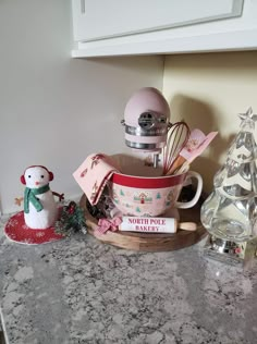 a kitchen counter top with a mixer and other items on it, including an ornament