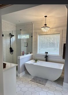 a large white bath tub sitting next to a walk in shower