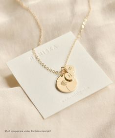 14K Solid Gold Personalized Disk Necklace * Tiny Initial Tags * Initial Disk Necklace * Small Letter Necklace * Dainty Letter Necklace PRODUCT DESCRIPTION Our Ava personalized medium disk necklace on our sparkly dainty chain can be engraved with your choice of text or a symbol.  Add up to four tiny disks engraved with an initial of your choice.  Combined, this necklace makes the perfect meaningful piece made just for you. Personalize the medium disk with a name, date, roman numerals, a large sym 14k Gold Filled Yellow Gold Necklace For Personalized Gift, Dainty 14k Stamped Initial Pendant Necklace, Mother's Day Personalized Tarnish-resistant Necklace, Everyday 14k Gold Necklace With Flower Charm, Everyday 14k Gold Necklaces With Flower Charm, Personalized 14k Gold-filled Necklaces For Wedding, Personalized 14k Gold-filled Pendant Necklace, Personalized 14k Gold Filled Necklaces For Wedding, Personalized 14k Gold Filled Pendant Necklace