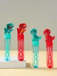 four little toy animals in plastic tubes with numbers on them