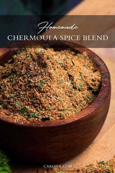 a wooden bowl filled with spices on top of a table