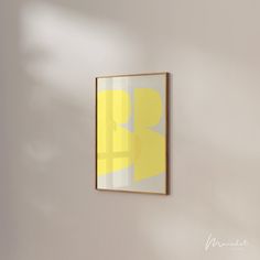 a yellow and white painting hanging on the wall