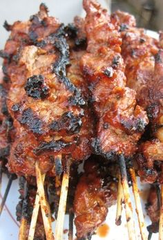 several skewered meats are being served on sticks