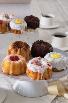 a white plate topped with donuts covered in frosting