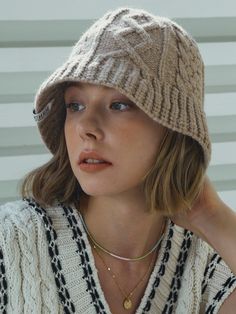 a woman wearing a knitted hat and sweater