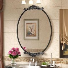 a bathroom with a sink, mirror and flowers in the vase on the counter top