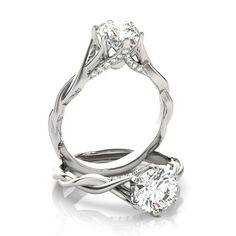 an engagement ring with two diamonds on the side and one diamond in the middle,