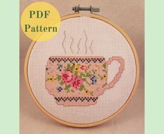 a cross stitch pattern with a tea cup on it