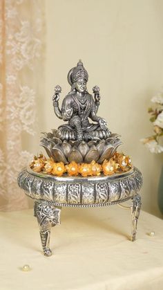 a silver statue sitting on top of a table