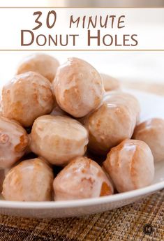 a white plate filled with donuts sitting on top of a table next to a napkin