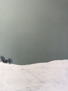 a lone tree stands in the middle of a snow covered field, against a gray sky