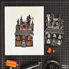 the paper is cut out and ready to be used for making halloween houses with scissors