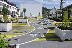 a bike path painted with yellow and white paint in the middle of an urban area