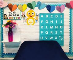 there is a bed with blue sheets and balloons on the wall above it, along with letters that spell out to children's names