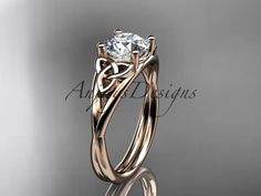 a beautiful engagement ring with an intricate design on the side and a round diamond in the center