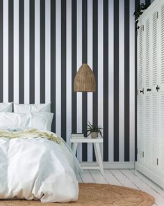 a bedroom with blue and white striped walls