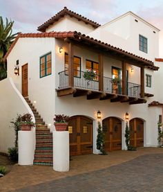 a large white house with lots of windows and balconies