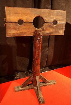 an old wooden stand with two holes in it