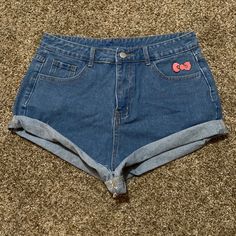 These Jean Shorts Feature Hello Kitty’s Signature Red Bow Above The Left Front Pocket And Hello Kitty’s Face On The Right Back Pocket. They Are Slightly High Waist And Have One Front Button And A Zipper. They Are Size Large And Fit Me Snug. I Wear A Size 4/6 In American Eagle Jeans. Cute High Waist Cotton Jean Shorts, Cute High Waist Cotton Bottoms, Cute Cotton Jean Shorts, Cute High-waist Cotton Bottoms, Cute Jean Shorts With Pockets, Cute Fitted Bottoms, Cute Short-length Bottoms With Pockets, Cute Fitted Short Length Shorts, Cute High Waist Denim Bottoms