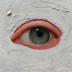 an eye with red and white paint on it