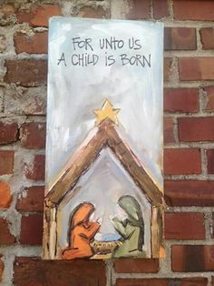 a nativity scene painted on the side of a brick wall with a star above it