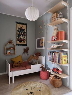 a child's room with bookshelves and toys