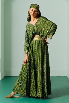 Green crop top with ajrakh hand block print and gold sequin, zari, thread, pitta embroidery. Paired with flared skirt.
Components: 2
Pattern: Hand Block Print, Embroidery
Type Of Work: Ajrakh, sequin, zari, thread, pita
Neckline: V neck
Sleeve Type: Draped sleeves
Fabric: Satin
Color: Green
Other Details: 
Embroidered waistband
Note: Face and hair accessory worn by the model is not for sale
Occasion: Sangeet - Aza Fashions Pitta Embroidery, Crop Top And Skirt Set, Draped Sleeves, Crop Top And Skirt, Crop Top Skirt Set, Satin Hands, Print Embroidery, Top And Skirt Set, Drape Sleeves