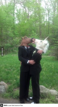 two men in suits are kissing and one is wearing a dog's head on his shoulders