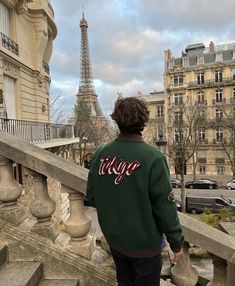 a man is walking down some stairs in front of the eiffel tower