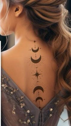 the back of a woman's neck with stars and moon tattoos on her left side