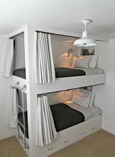 two white bunk beds sitting next to each other