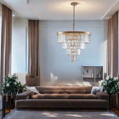 a living room filled with furniture and a chandelier hanging over the top of it