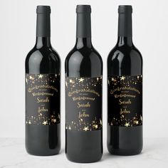 three bottles of wine with gold stars on them