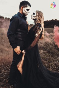 a man and woman in skeleton makeup standing next to each other