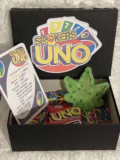 an uno box filled with different types of candy and other items to play with in the game