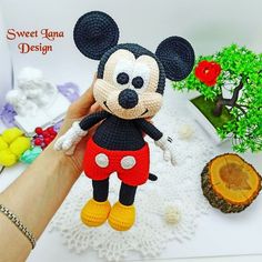 a crocheted mickey mouse doll sitting on top of a table