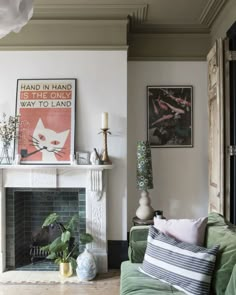 a living room filled with furniture and a fire place in front of a painting on the wall