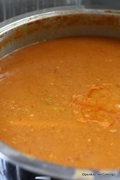 a pot filled with soup sitting on top of a stove