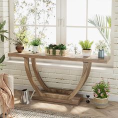 a wooden table sitting in front of a window filled with potted plants