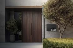 an entrance to a building with a wooden door and planter next to it that says 350