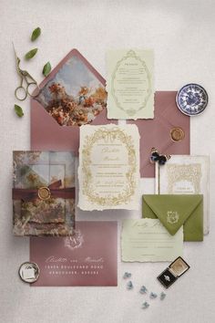 the wedding stationery is laid out on top of each other, including an envelope