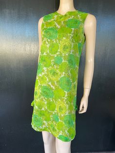 "1960s Kitty Copeland dress. Green floral on polyester chiffon, green acetate liner. Simple column shape. Two decorative bows on sides near hem. Nylon zip back. Measurements are  36\" bust 34\"waist 36\" hips 36\" length 14\" back shoulders (between armholes) Lovely dress shows well, some repairs noted by left bow as shown in pics." Mod Green A-line Dress, Green Knee-length Mod Dress, Green Mod Knee-length Dress, Green Silk Knee-length Dress, Green Knee-length Silk Dress, Green Mod A-line Dress, Green A-line Silk Dress, Green Silk A-line Dress, Green Silk Dress For Garden Party