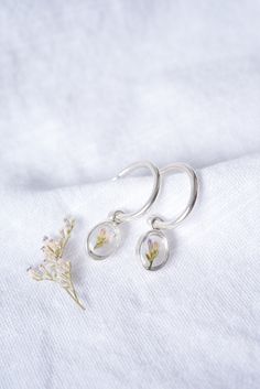 Pressed Flower Earrings- Mini Oval Hoops | By Ephemera Create your story... Floriography is the language of flowers, in which each botanical symbolizes a special meaning, message, or feeling. Your pressed flower earring keepsake empowers you to create and share your own story, using botanicals in place of words. Capture in time your most special moments, major milestones, triumphs and trials. Crafted using fine and .925 sterling silver, as well as hand-picked and pressed flowers preserved beneath crystal clear glass, each earring set has been expertly shaped, soldered, sanded, set, and polished in-house by hand, quality unmatched. We all have a story. Start telling it today. DETAILS: ❀Select your pressed flower: Caspia, Fern, Flowering Thyme, Forget-Me-Not, Queen Anne's Lace ❀Mini oval mea Flowering Thyme, Botanical Ring, Pressed Flower Earrings, The Language Of Flowers, Botanical Earrings, Create Your Story, Queen Anne's Lace, Flower Earring, Language Of Flowers