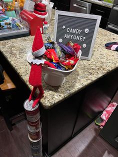 an elf is sitting on top of a counter with candy