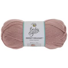 a ball of yarn with the words baby bee sweet delight in white and pink on it